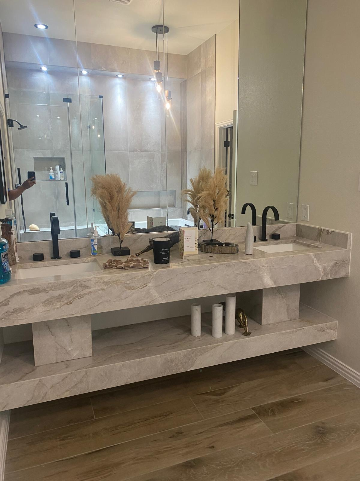 Double vanity with marble countertop and backsplash